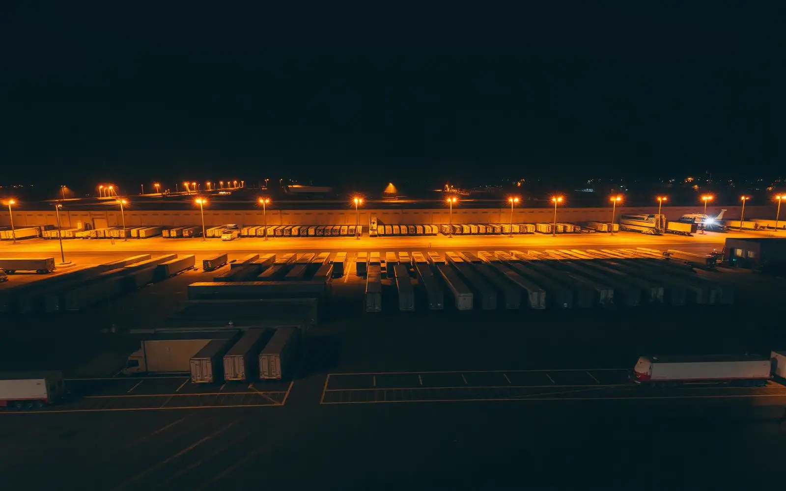 Freight yard with rows of trailers at night